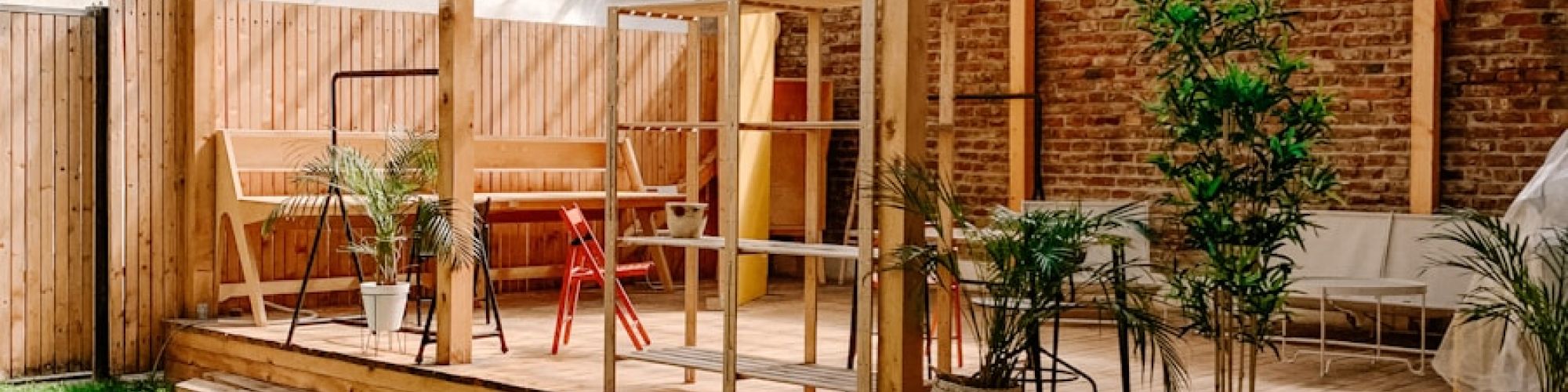 brown wooden fence near green plants during daytime