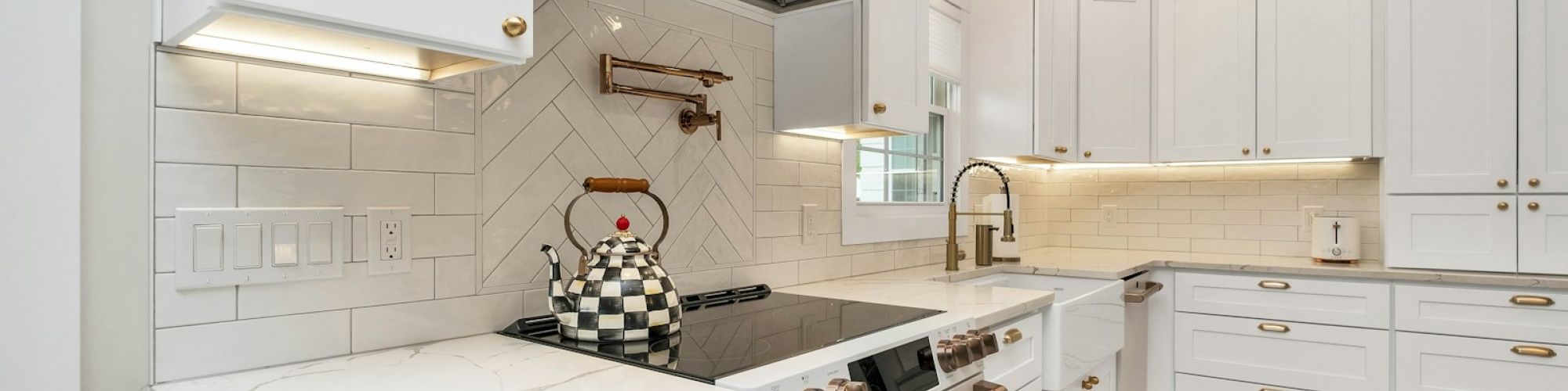 a kitchen with white cabinets and a stove top oven